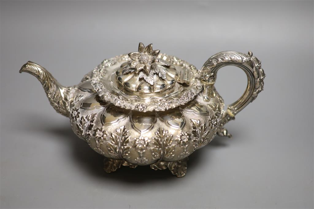 A George IV silver squat melon shaped teapot, embossed with flowers, The Barnards, London, 1829, gross 28oz.